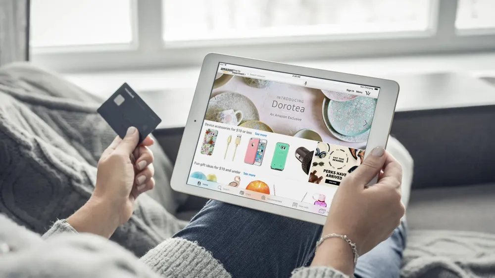 Woman using Amazon app on a brand new Apple iPad Pro Silver for online shopping
